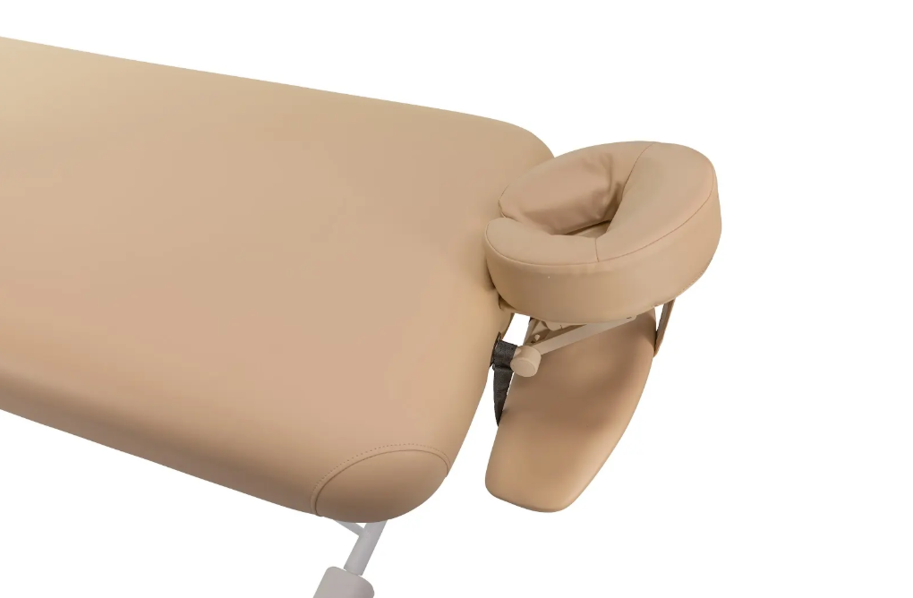 Beige massage table headrest with padded face cushion.