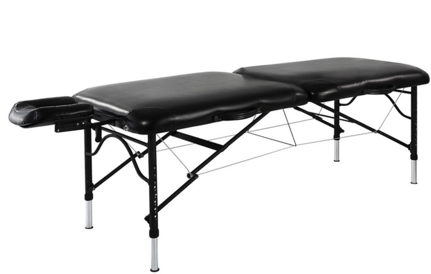 Black Portable massage table with adjustable metal legs.